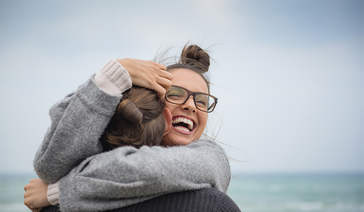 Caucasian couple hugging on beach