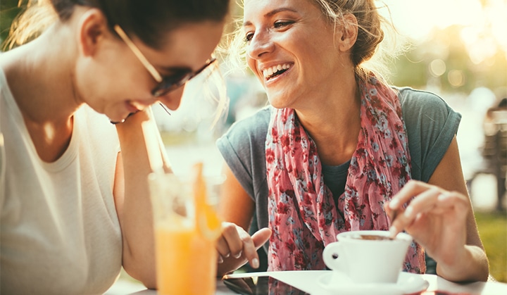 Female friends talking in cafe